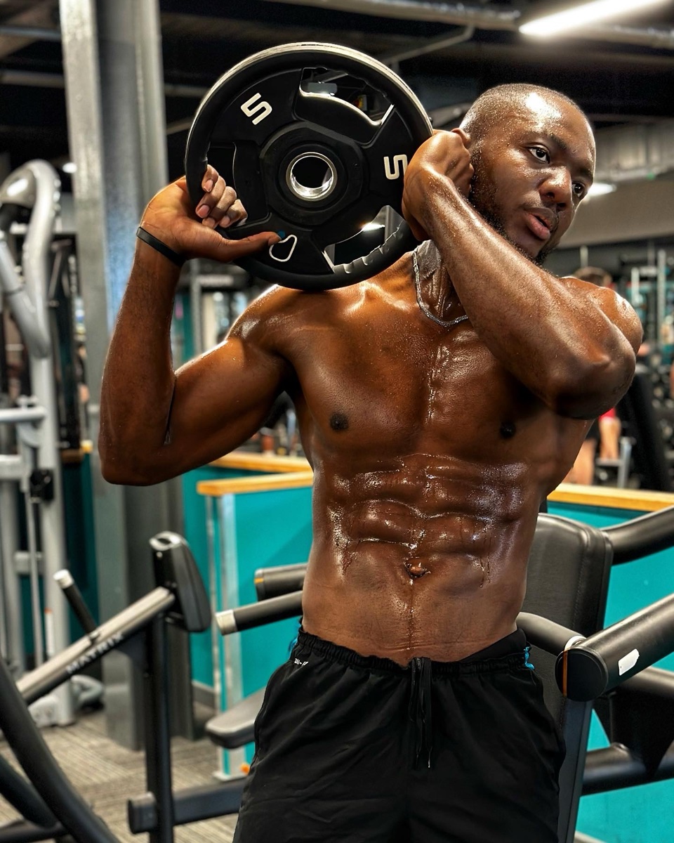 Joe Hardy holding a weight plate